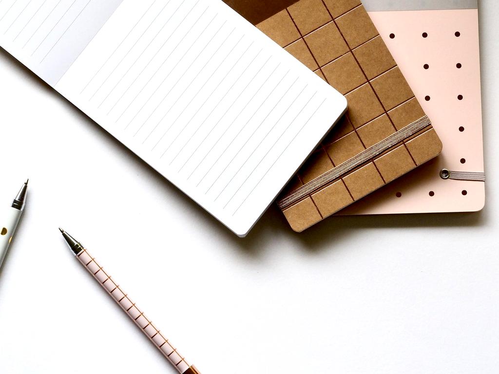 Collection of books, digital tools and workspace set up for learning